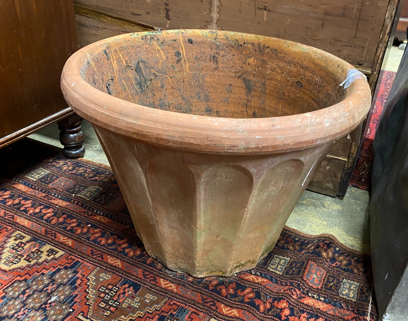 A circular terracotta garden planter, diameter 54cm, height 39cm